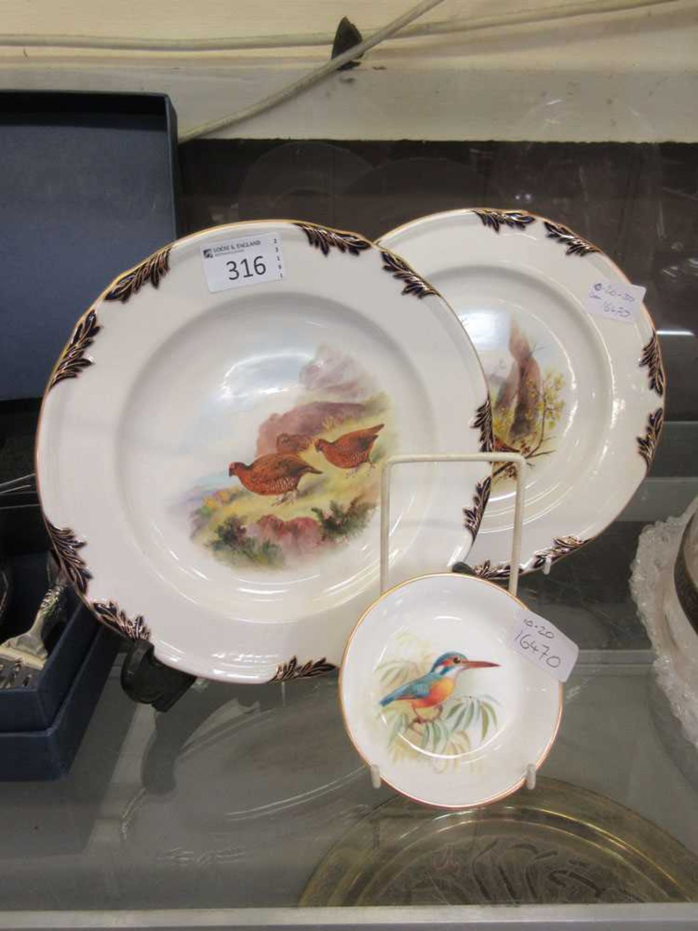 Two Royal Worcester side plates with Woodcock and Grouse designs along with a Royal Worcester pin