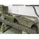 A pair of composite stone garden troughs with latticework bodies