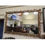 An ornate gilt framed rectangular mirror