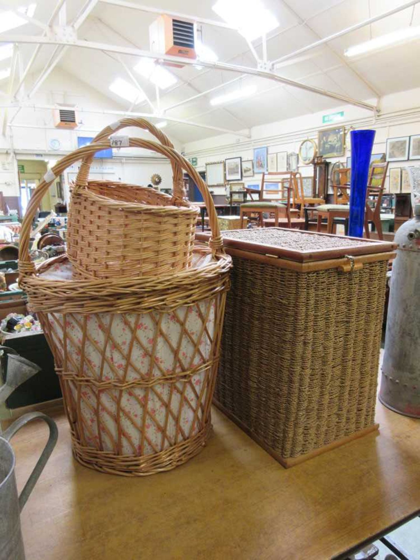 Two wicker baskets together with a seagrass linen basket