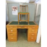 An early 20th century oak pedestal desk with green leather insert with associated chair