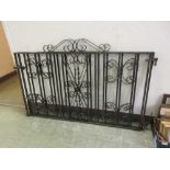A pair of wrought iron black painted low level gates