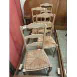 A set of four beech framed rush seated kitchen chairs