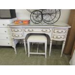 A white and parcel gilt dressing table with associated stool