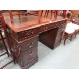 A reproduction mahogany twin pedestal desk with tooled brown leather insert