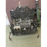 A cast iron fire back along with grate and dogs