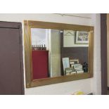 A modern gilt framed bevel edged rectangular mirror