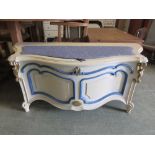 A cream, blue and parcel gilt serpentine fronted Ottoman