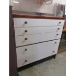 A chest of five drawers with painted front