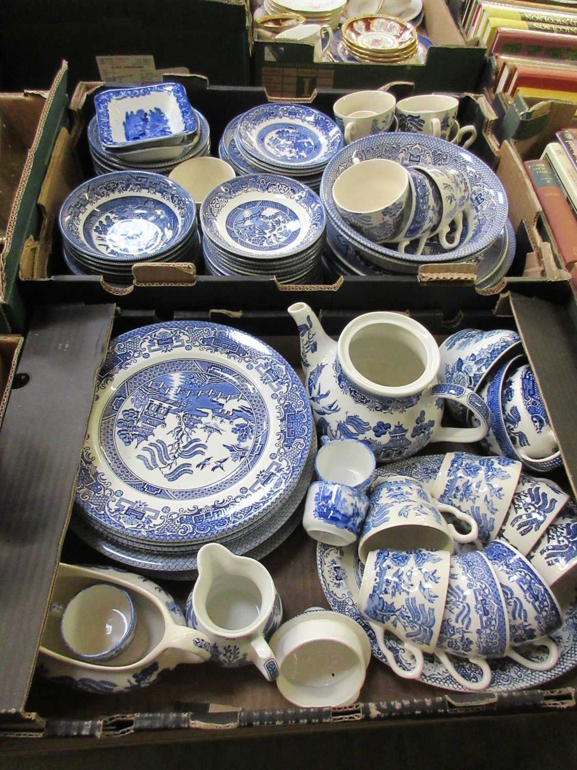 Two trays of blue and white willow style table ware