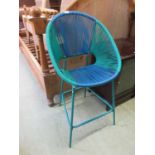 A green and blue PVC strung chair on a green painted metal support