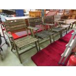 A set of four weathered wooden garden folding chairs