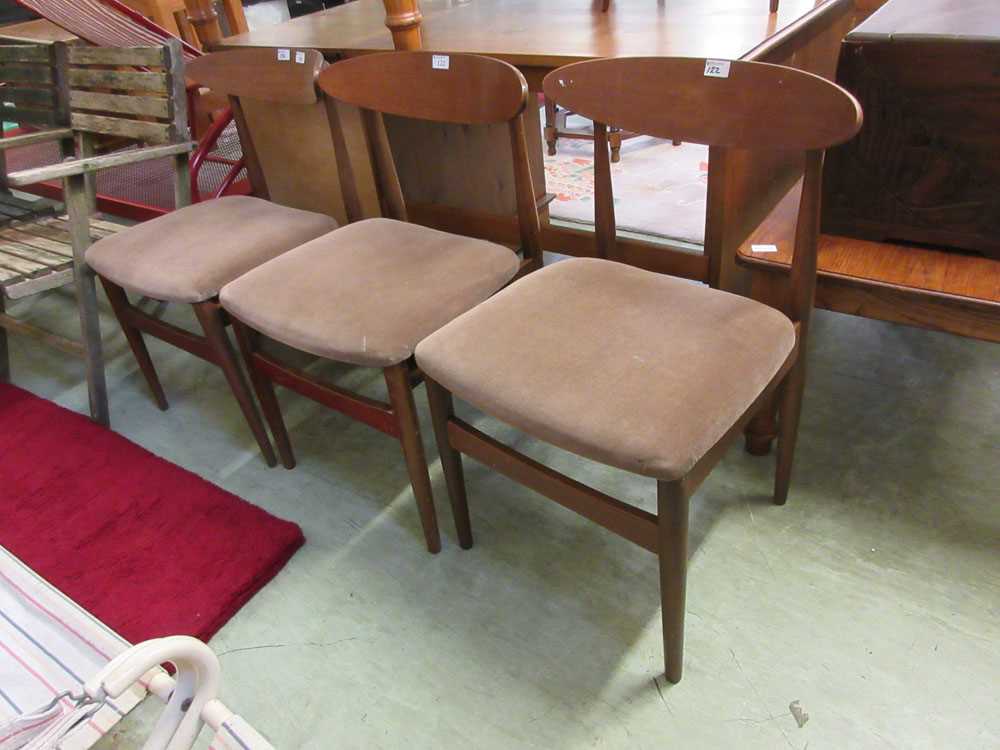 A set of three mid-20th century teak dining chairs.