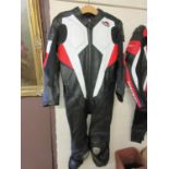 A black, red and white leather motorcycle suit by Saramoto