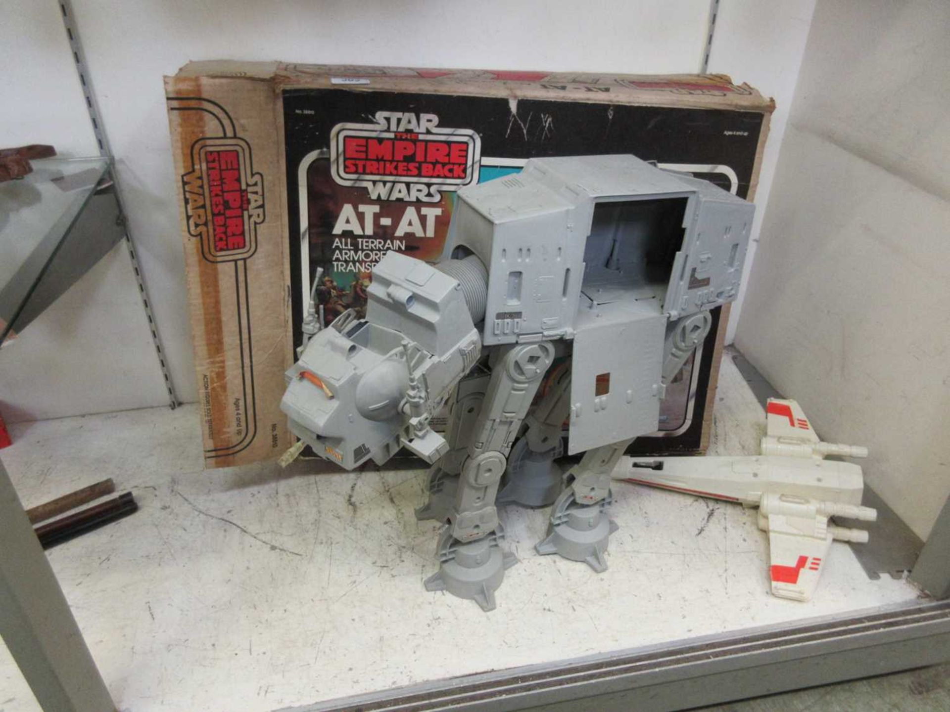 A Star Wars 'The Empire Strikes Back' AT-AT with box along with a Star Wars Star Fighter