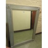 A modern silvered frame rectangular wall mirror