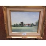 A framed and glazed watercolour of windmill scene signed bottom right