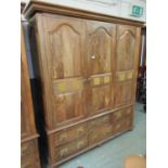 An eastern hardwood high quality three door wardrobe having six drawers below