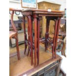 A nest of three eastern hardwood occasional tables.