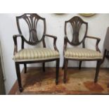 A pair of early 20th century 18th century style mahogany child's open arm chairs in the manner of