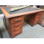 An early 20th century oak twin pedestal desk.