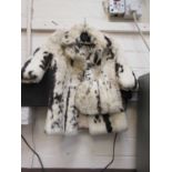 A small child's fur coat