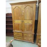An eastern hardwood high quality wardrobe having a pair of cupboard doors above four drawers