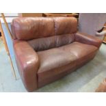A tan leather two seater settee.