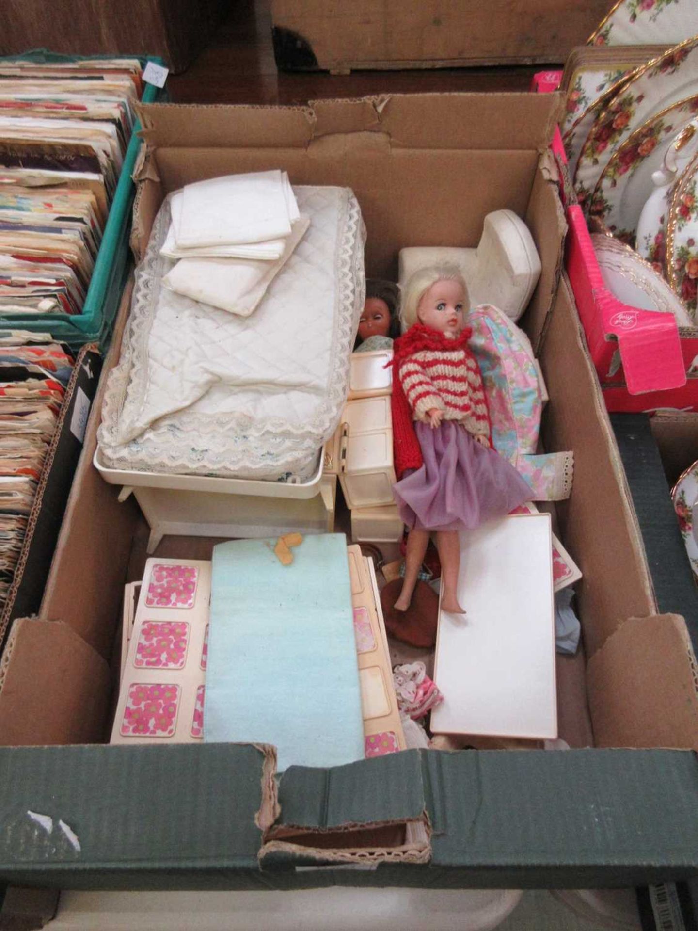 A tray containing a Sindy doll, one other doll, and a selection of furniture