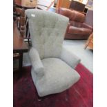 A reproduction Victorian style button back chair upholstered in a green cut fabric.
