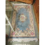 A blue ground floral Chinese style rug