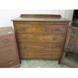 An early 20th century oak chest of four long drawers