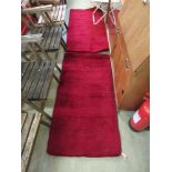 A pair of red wool rectangular rugsNo apparent damage.