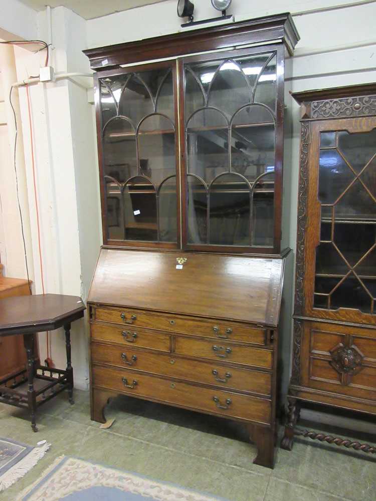 An early 20th century mahogany bureau bookcase with astragal glazed doors over fall front and bank