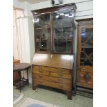 An early 20th century mahogany bureau bookcase with astragal glazed doors over fall front and bank