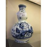 A blue and white vase with floral design marked to base Royal Delft Blue