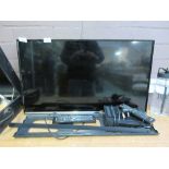 A Samsung flatscreen television along with wall bracket, IView unit and remotes