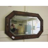 An early 20th century oak framed bevel glass mirror