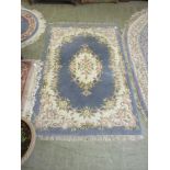 A blue ground floral rectangular Chine style rug