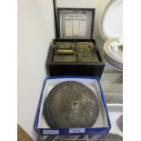 A 19th century boxed Symphonion with an assortment of disks