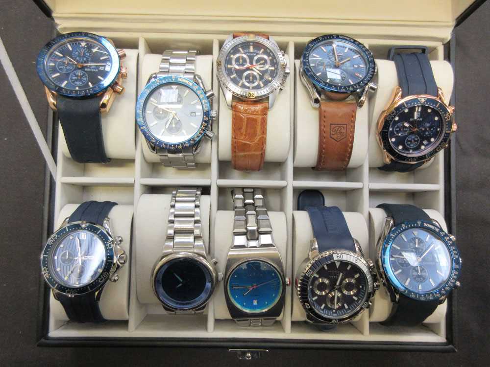 A watch case containing ten gent's wristwatches to include Accurist, Paul Smith, Benyar, etc