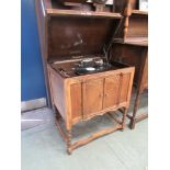 An early 20th century Melogram gramophone player in oak cabinet with a selection of 78 rpm records