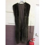 A dark brown faux fur sleeveless coat