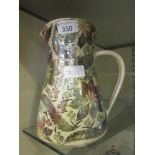 A mid-20th century Poole water jug with leaf design signed to base 'L.Whitmarsh'