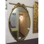 A gilt metal oval mirror