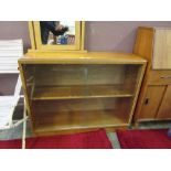 A mid-20th century teak bookcase with glazed sliding doors