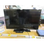 A flat screen TV with remote