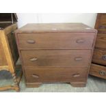 An early 20th century oak chest of three long drawers