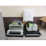 A collection of office binding machines and a large quantity of binding materials