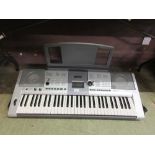 A Yamaha E403 keyboard with stand